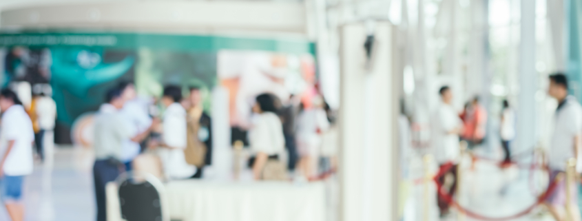 Blurred background : people shopping at market fair in sunny day
